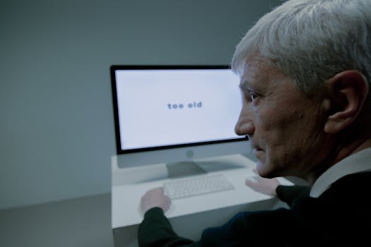 Senior man confronted with ageism on computer screen in job search.