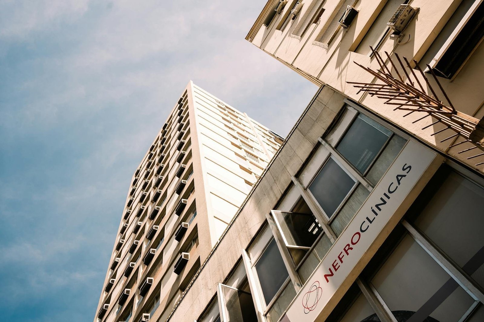 Low angle view of a modern office building in Rio de Janeiro under a blue sky.
