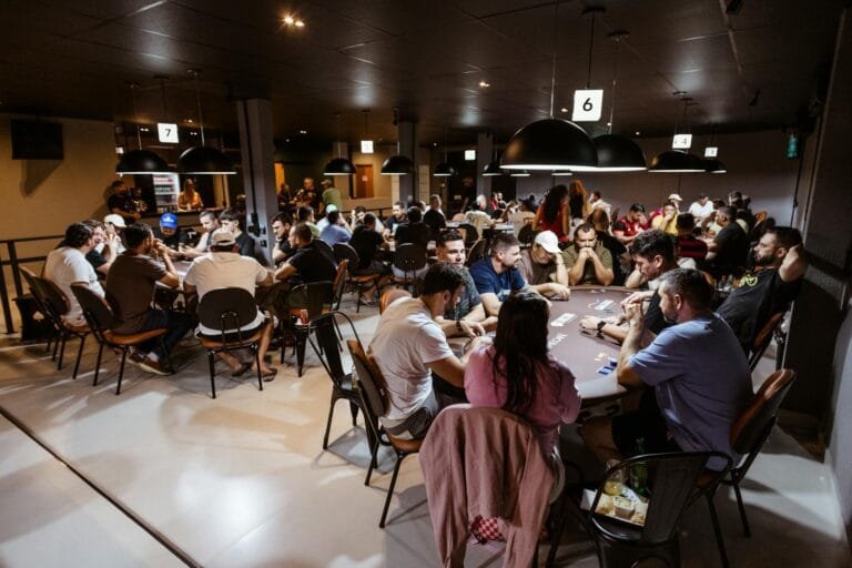 Intense poker game in a lively casino with multiple players. Experience the thri