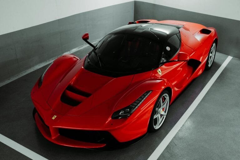 A stunning red Ferrari supercar parked indoors, showcasing luxury and performance.
