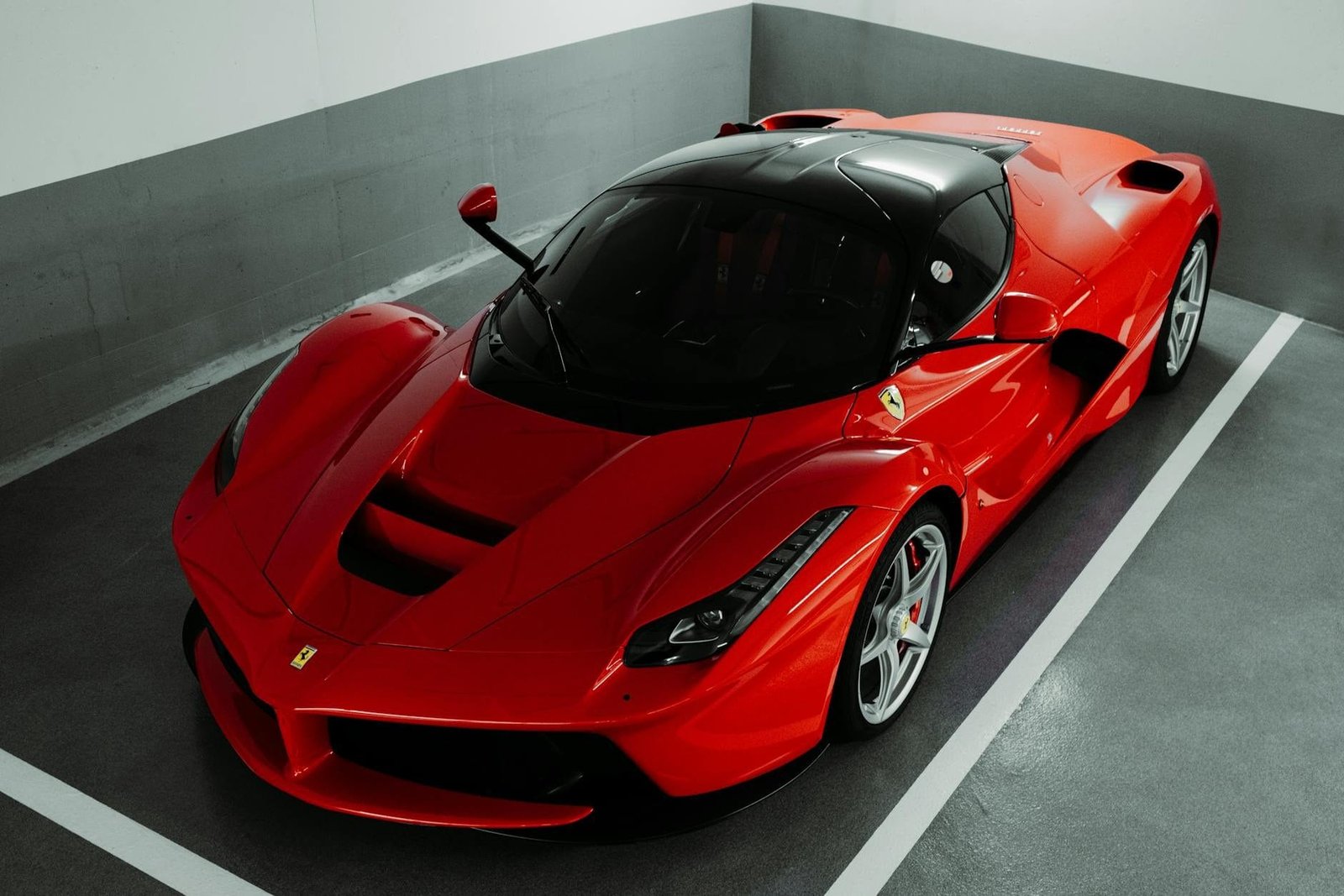 A stunning red Ferrari supercar parked indoors, showcasing luxury and performance.