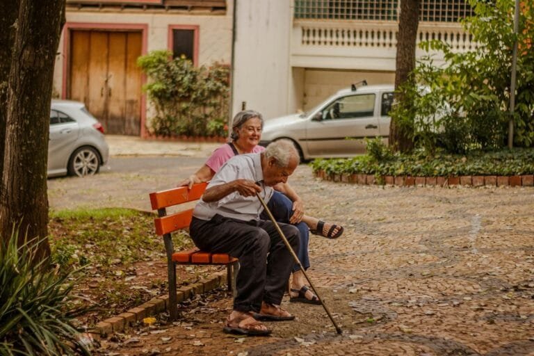 Senior couple enjoying a peaceful moment on a park bench in an urban setting wit
