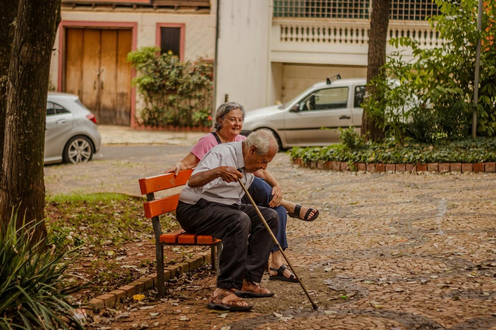 Senior couple enjoying a peaceful moment on a park bench in an urban setting wit