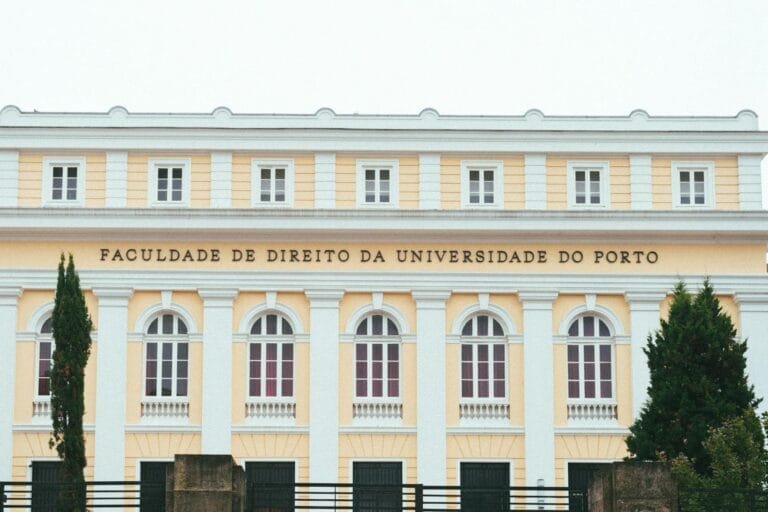Facade of the Faculty of Law at the University of Porto, showcasing classic arch
