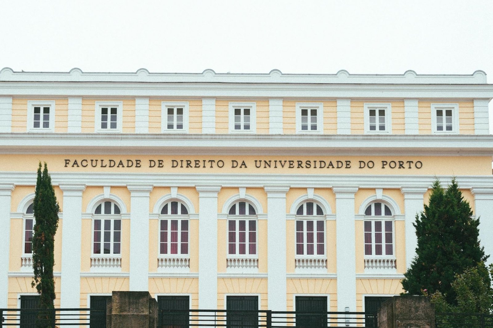 Facade of the Faculty of Law at the University of Porto, showcasing classic arch