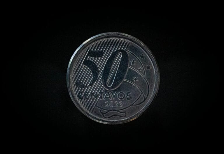 Detailed macro shot of a 50 Centavos coin from 2023 on a dark background.