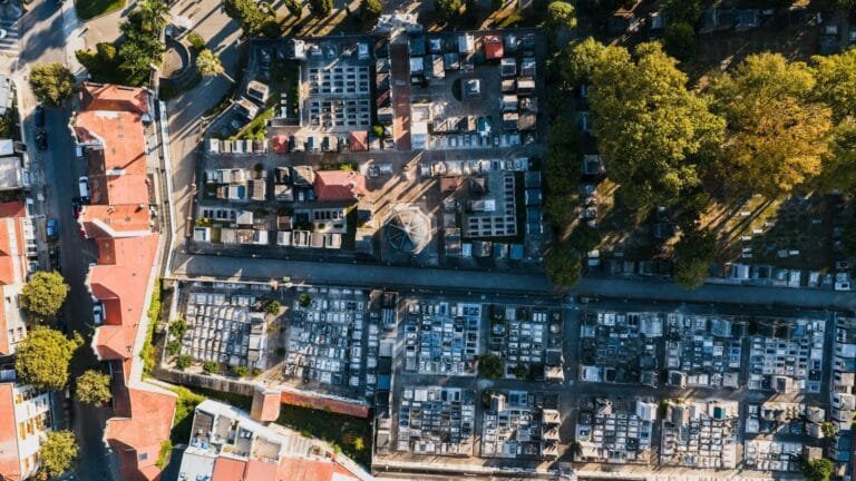 Drone shot capturing the layout of a cemetery surrounded by residential building