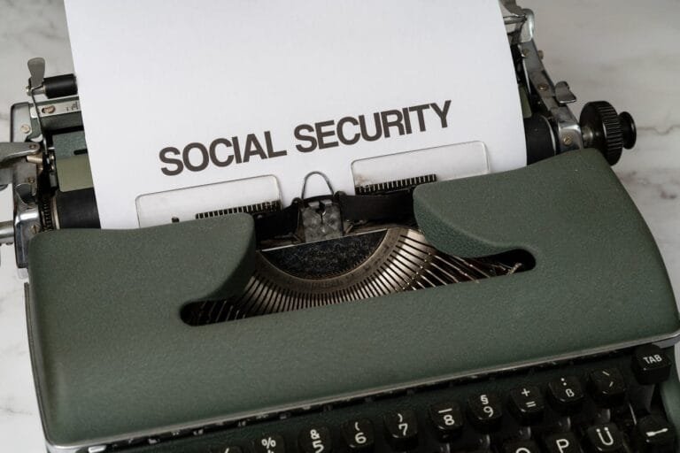 Close-up of a vintage typewriter typing SOCIAL SECURITY on paper.