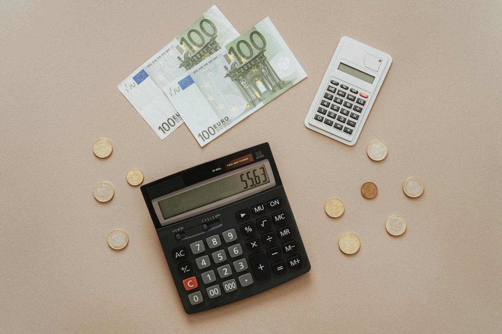 Flat lay of calculators and Euro currency, depicting financial calculations and