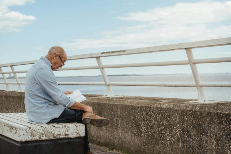 Side view of serious aged male wearing casual clothes and eyeglasses engaged in 