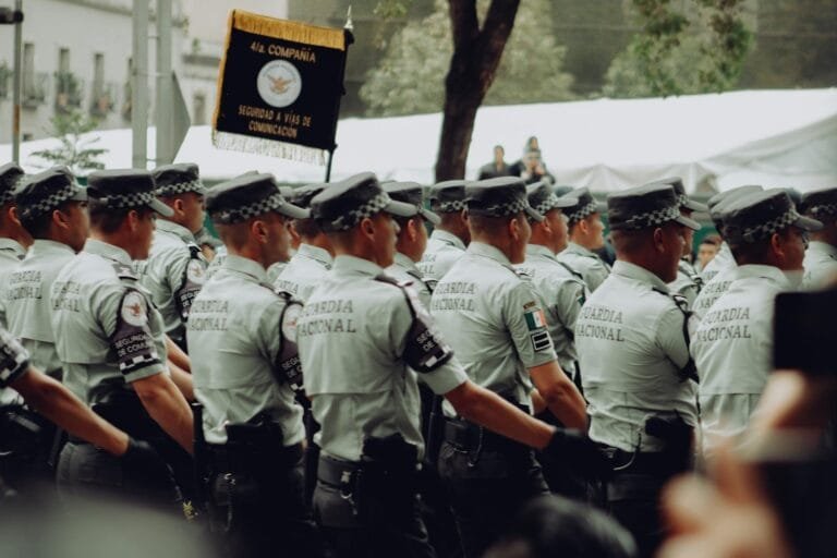 A group of uniformed National Guard soldiers marching in formation during a para
