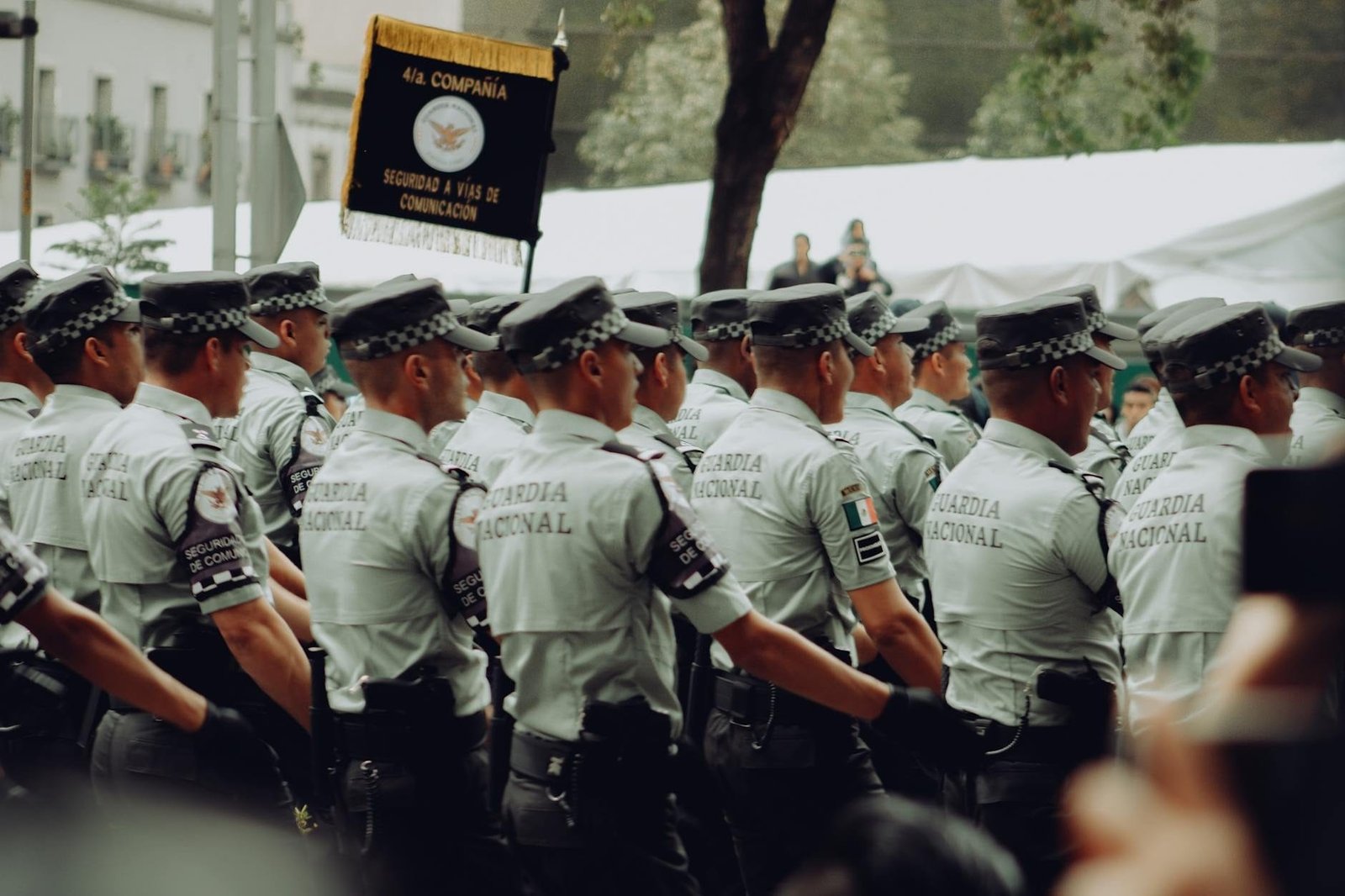 A group of uniformed National Guard soldiers marching in formation during a para