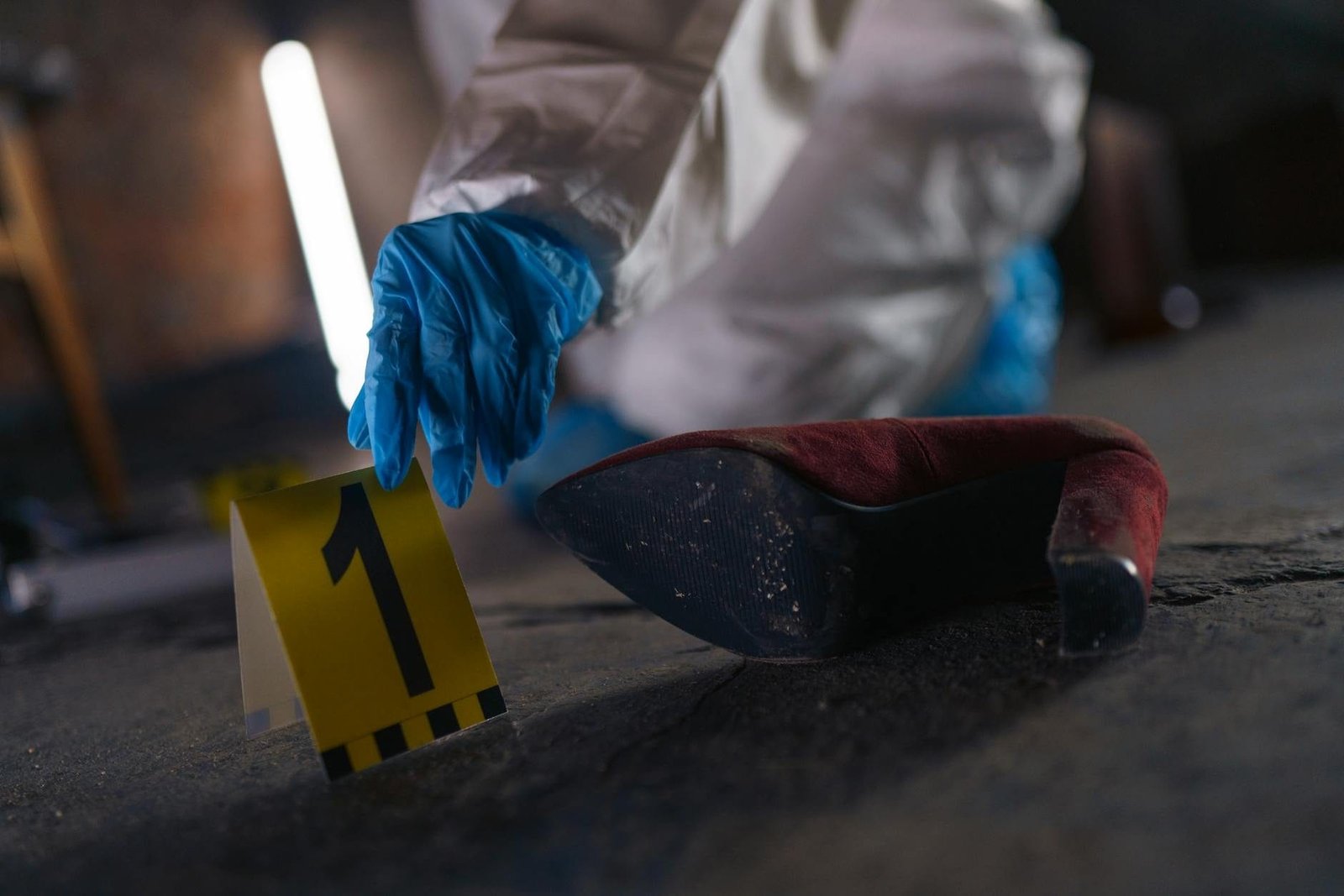Crime scene investigation with shoe as evidence marked with number one and foren