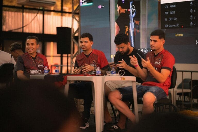 A group of e-sports players participating in a gaming event, focused on smartpho