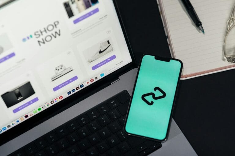 A smartphone and laptop displaying online shopping platforms, suggesting digital