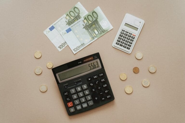 Flat lay of calculators and Euro currency, depicting financial calculations and 