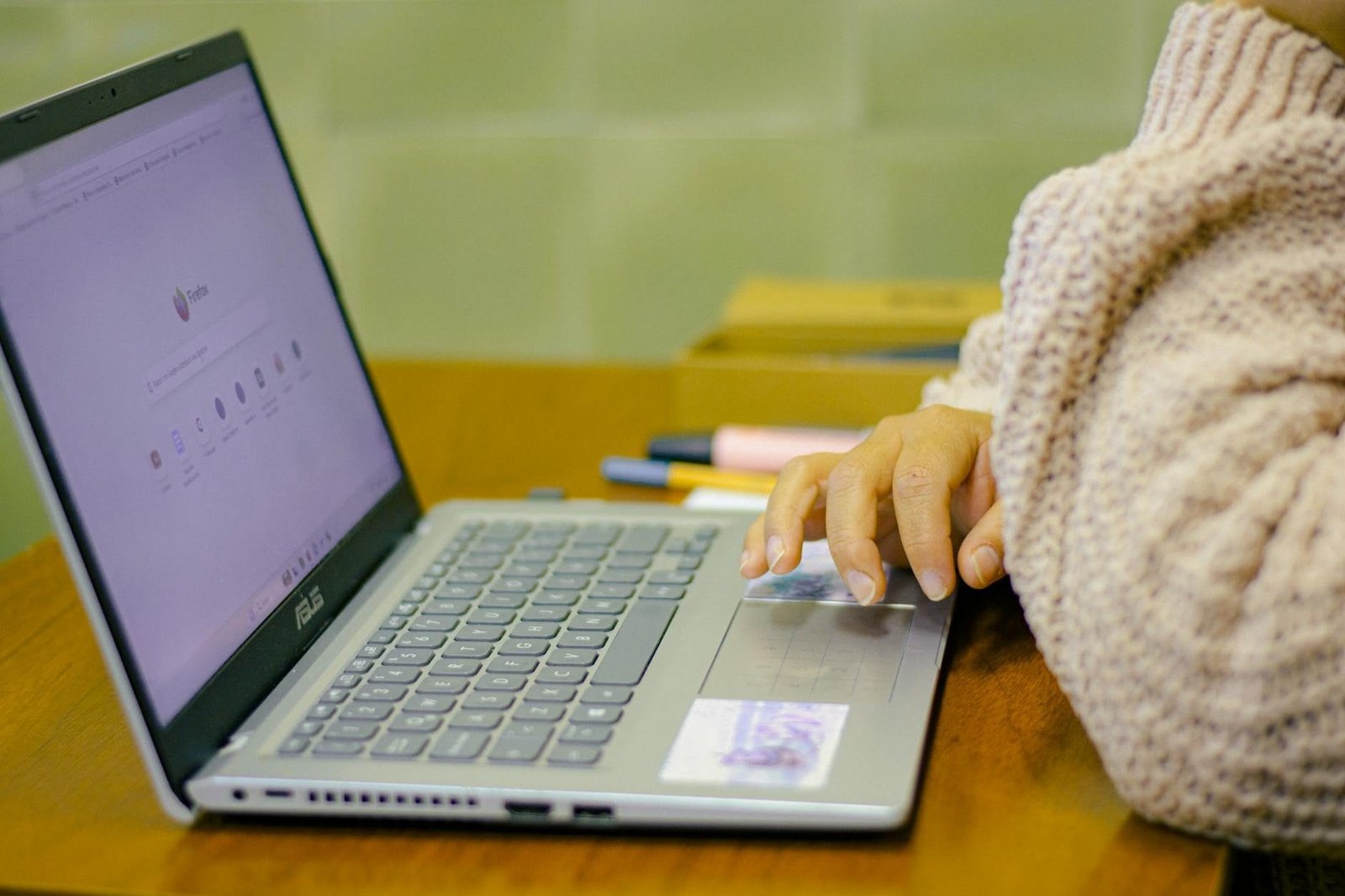Salário-Maternidade: Quem Recebe e por Quanto Tempo 1 Close-up of a student using a laptop with stationery on a wooden desk in a cozy