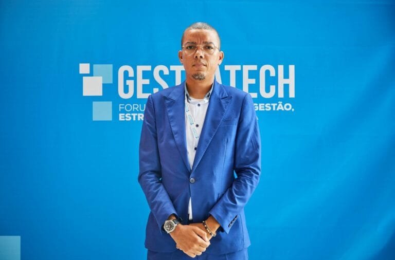 Confident businessman in blue suit at a professional conference event.