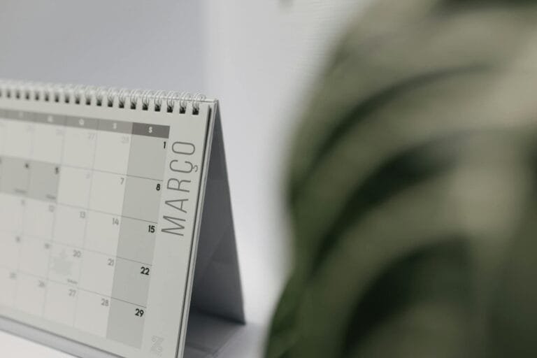 A close-up shot of a desk calendar open on March, with a soft, minimalistic back