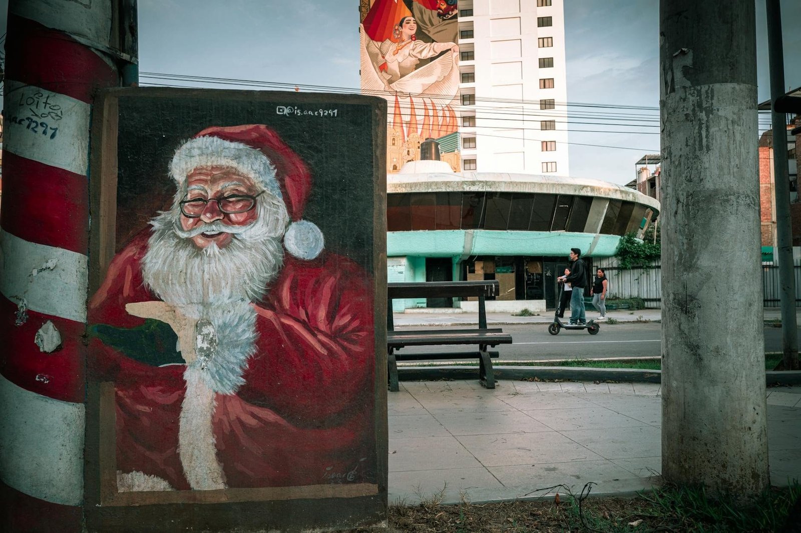 Street art of Santa Claus on a colorful mural in Trujillo, Peru, with urban back
