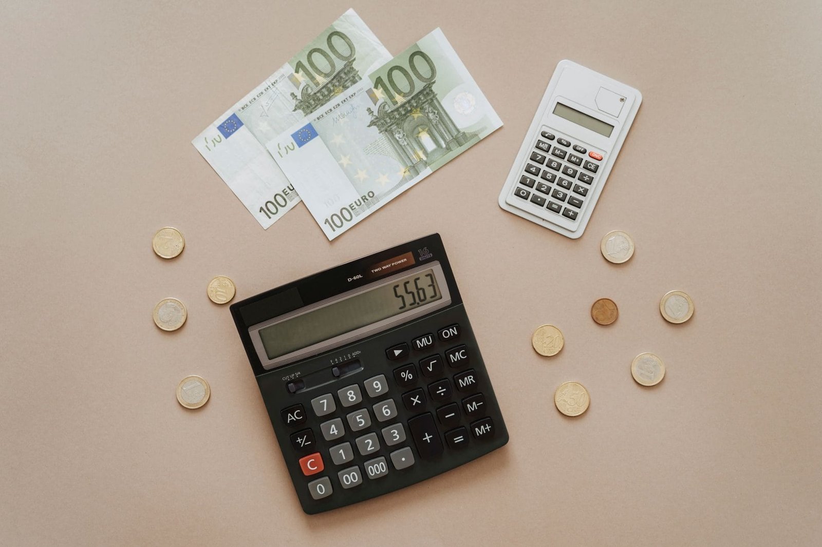 Flat lay of calculators and Euro currency, depicting financial calculations and