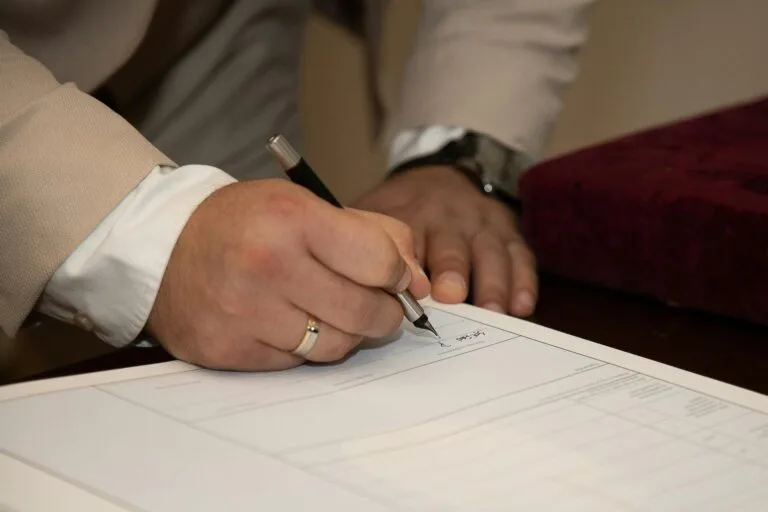 Casal assinando contrato sobre regime de bens do casamento
