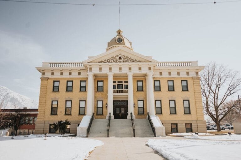 A prominent historic building in Brigham City, Utah, covered in snow during winter.