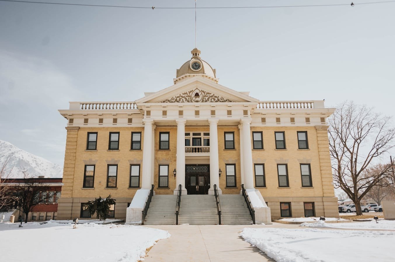 A prominent historic building in Brigham City, Utah, covered in snow during winter.