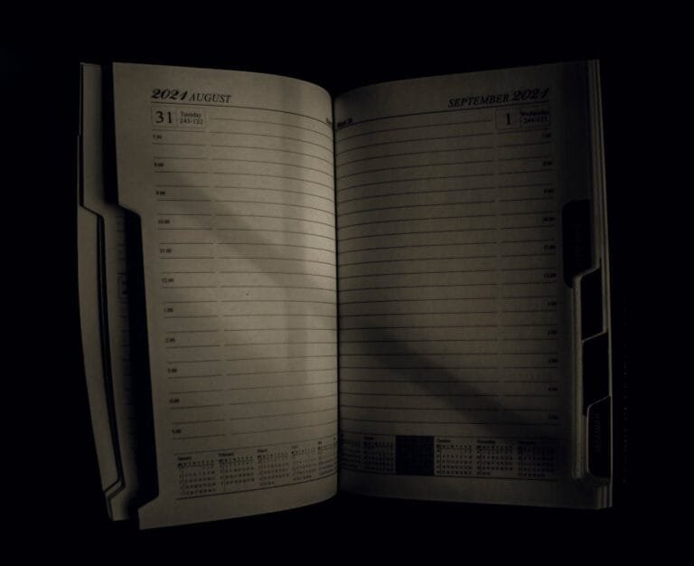 An open planner showing the transition from August to September 2021, symbolizing time management.