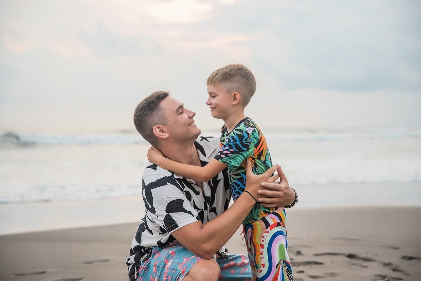 Heartwarming moment of a father and son bonding at the beach, showcasing love and connection.
