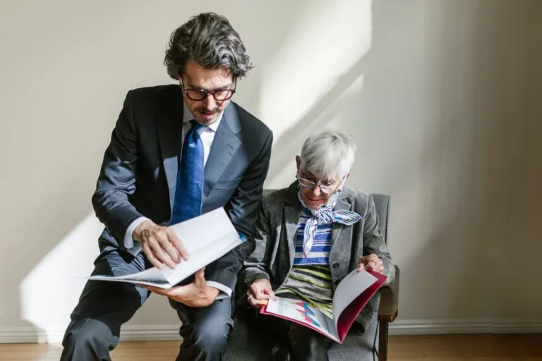 Business professionals reviewing documents in a bright office setting.