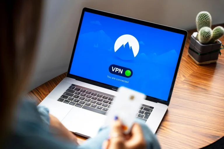 A person using a VPN on a laptop, symbolizing secure internet browsing in a modern indoor 
