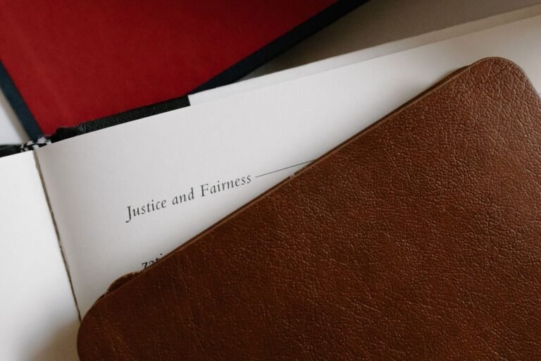 Leather-bound journal and open page titled Justice and Fairness.