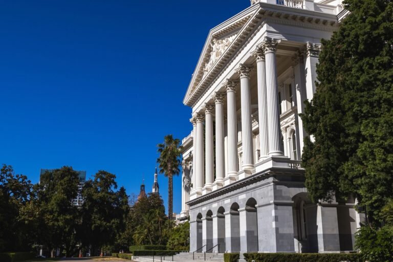 Beautiful sunlit view of the California State Capitol building with classic columns and vi