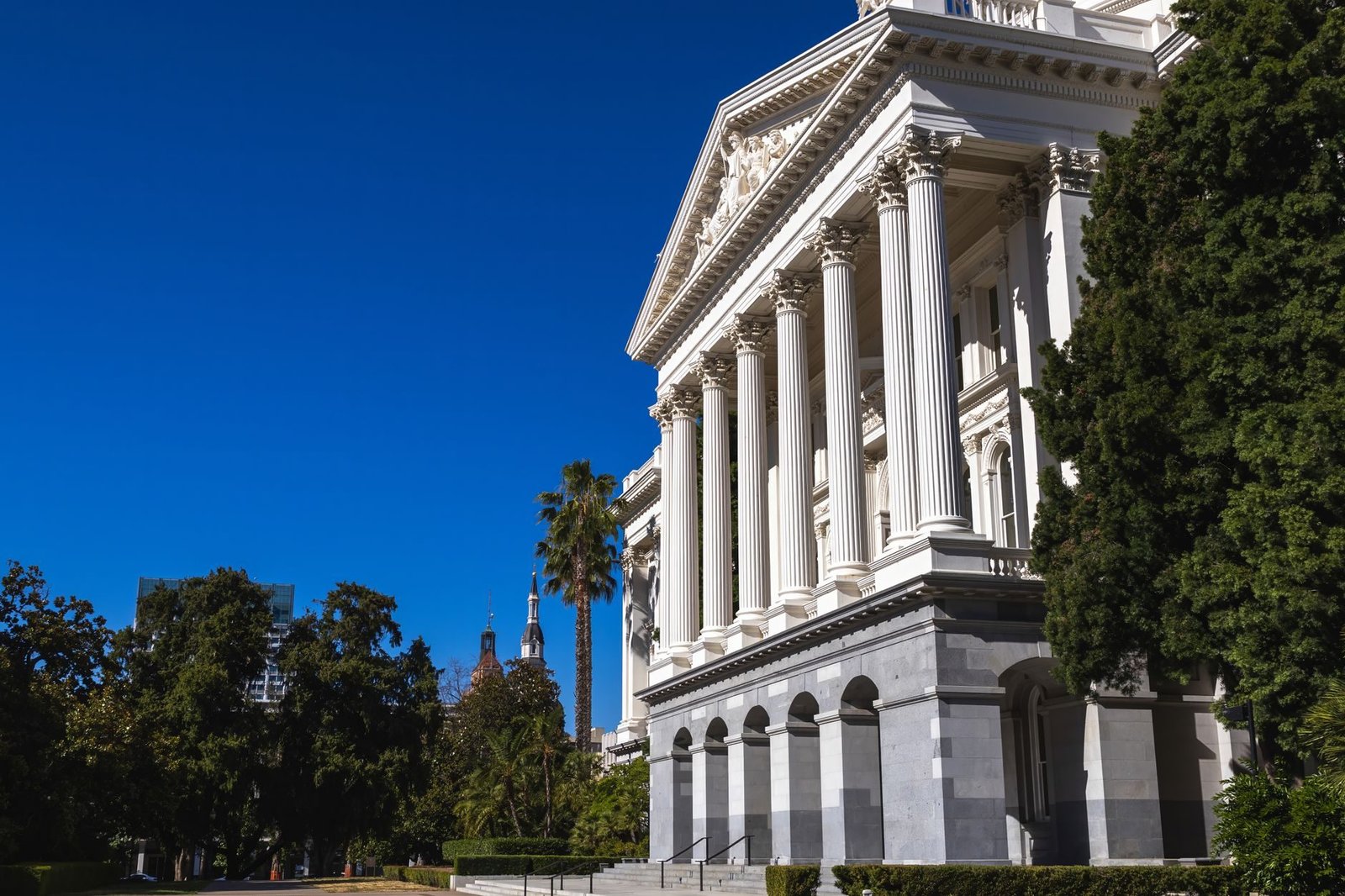 Beautiful sunlit view of the California State Capitol building with classic columns and vi