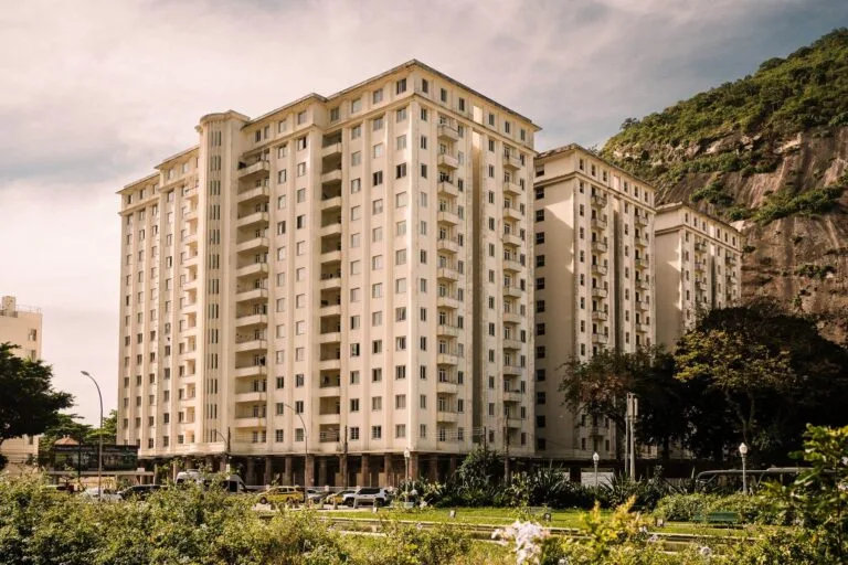 A contemporary residential building in Rio de Janeiro with a scenic mountain backdrop and 