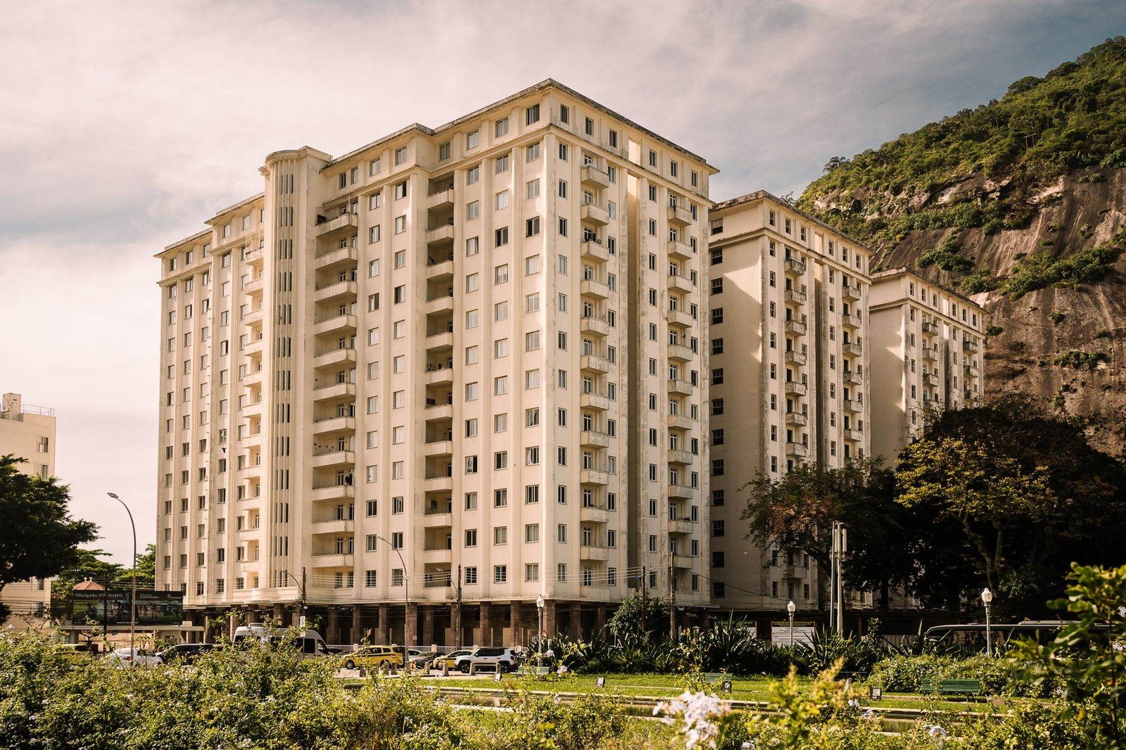 A contemporary residential building in Rio de Janeiro with a scenic mountain backdrop and