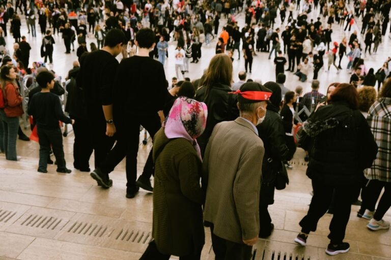 A bustling crowd descends city steps, highlighting diverse urban life.