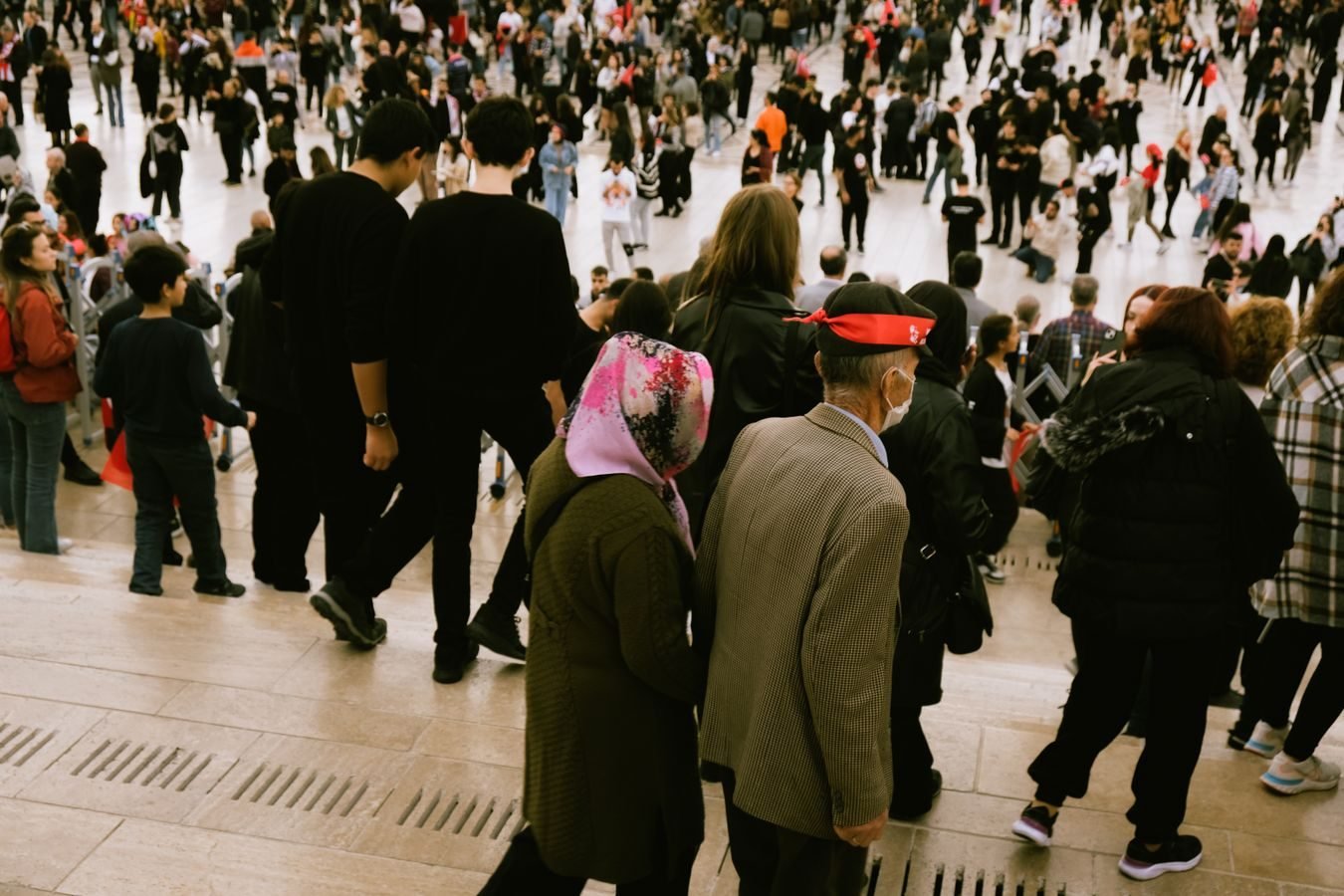 A bustling crowd descends city steps, highlighting diverse urban life.