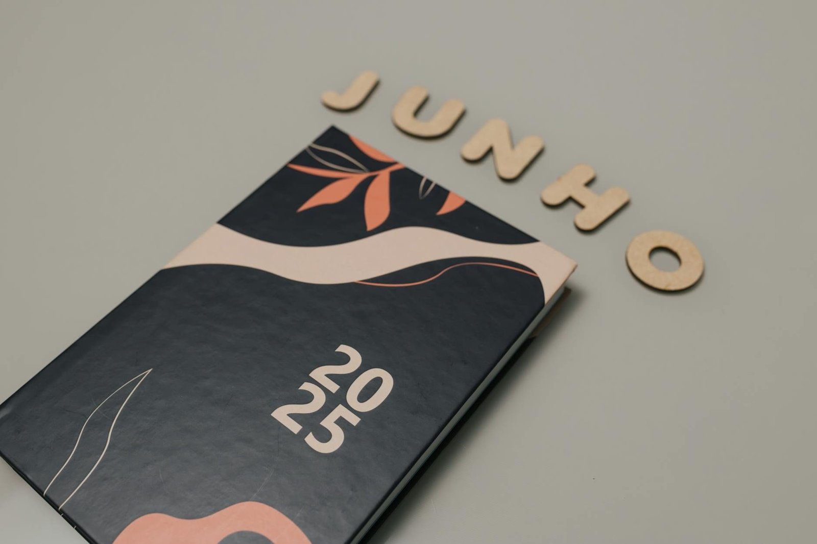 A sleek 2025 planner with a modern design sits beneath cutout letters spelling