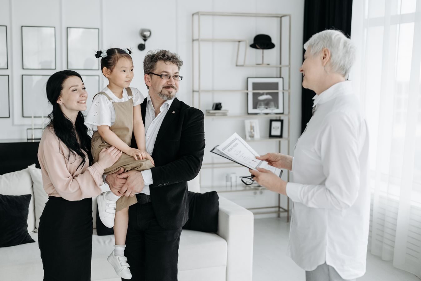 A joyful adoptive family meeting with a social worker indoors.