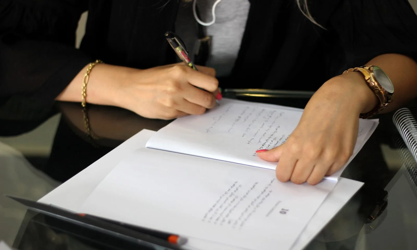 a person writing on a piece of paper