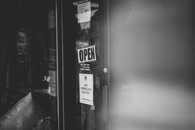 Black and white photo of an open sign on a thrift store door in Minnesota.