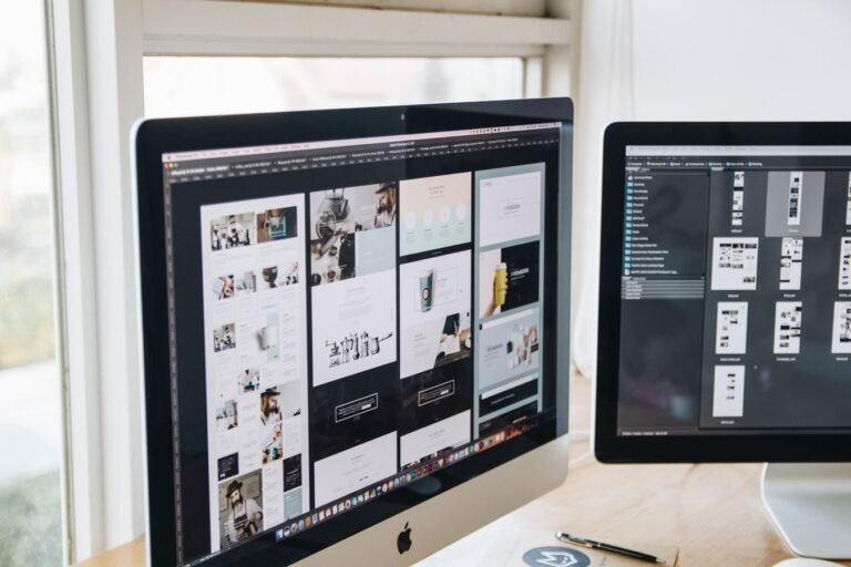 Modern office desk setup with dual monitors displaying design software, ideal for tech and business themes.