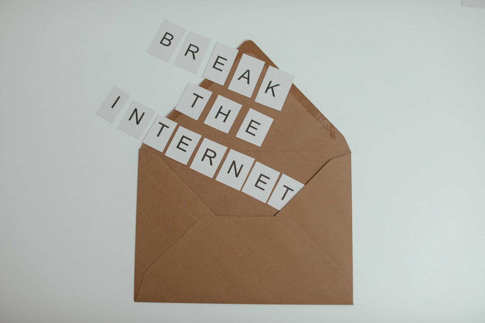 Brown envelope with tiles spelling 'Break the Internet' creates a conceptual and modern th