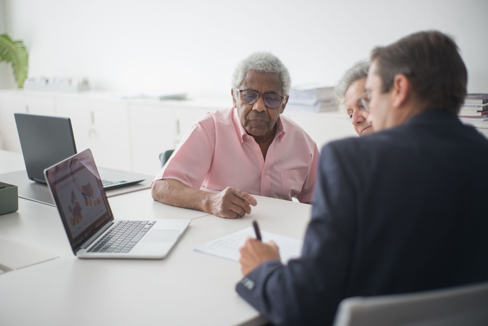 TNU fixa Tema 384 e admite efeitos financeiros da complementação de contribuições de alíquota reduzida (5% ou 11%) na DIB/DER do segurado, inclusive MEI 1 Senior couple discussing insurance options with a consultant in an office setting.