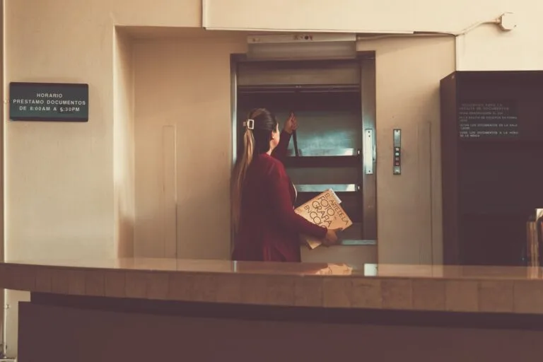 Woman using a dumbwaiter in a library in San José, Costa Rica.