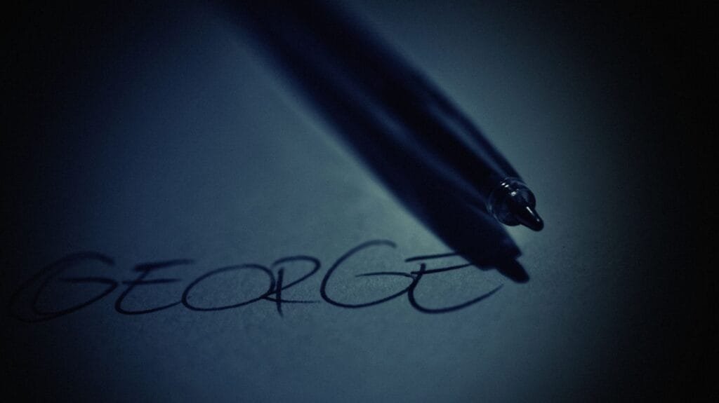 A professora Helena teve a progressão na carreira reconhecida na Justiça 1 Artistic close-up of a pen casting shadow on handwritten name George in soft dark lighting.