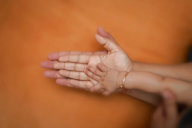 A touching close-up of a parent's hand holding a child's hand, symbolizing family unity.