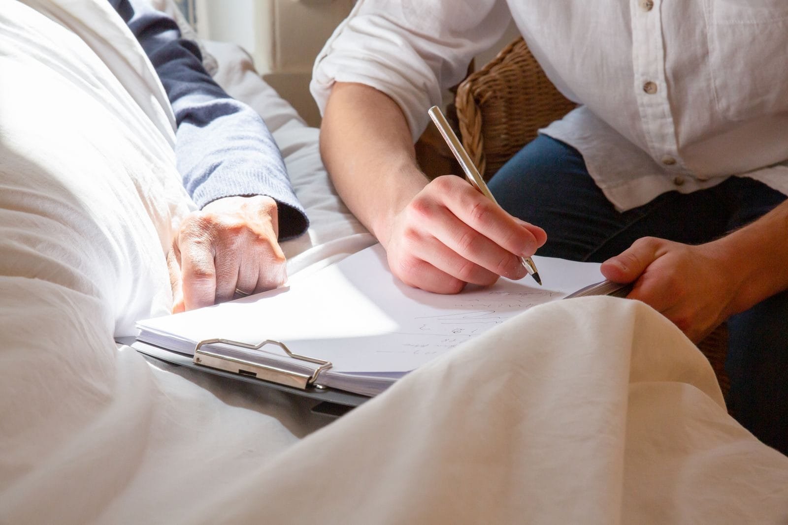 A caregivers supportive interaction with a senior in a sunlit room, highlighting care and connection.
